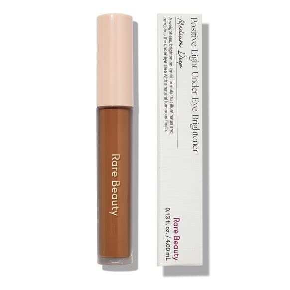 Rare Beauty Positive Light Under Eye Brightener in an array of flexible shades, the ultra-fluid formula makes blending quick and seamless while soothing skin on contact.