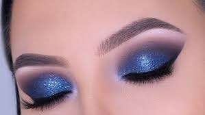 I choose a captivating shimmery blue for the inner two-thirds of my lid, adding depth with navy blue on the outer corners. Blending seamlessly, I create a mesmerizing "Smokey eye makeup" look. The lower lash line follows suit for continuity, and a few coats of mascara or falsies intensify the gaze.