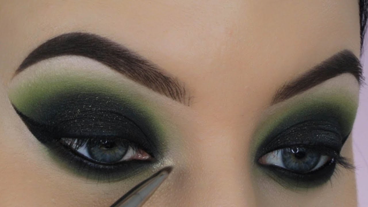 Evenly applying a green eye pencil to my inner two-thirds, I fill the crease with a light green shadow. A deep emerald center, blended for a blurred "Smokey eye makeup" effect. Shimmery green adds glamour, and a black gel liner shapes a cat-eye on both lash lines.